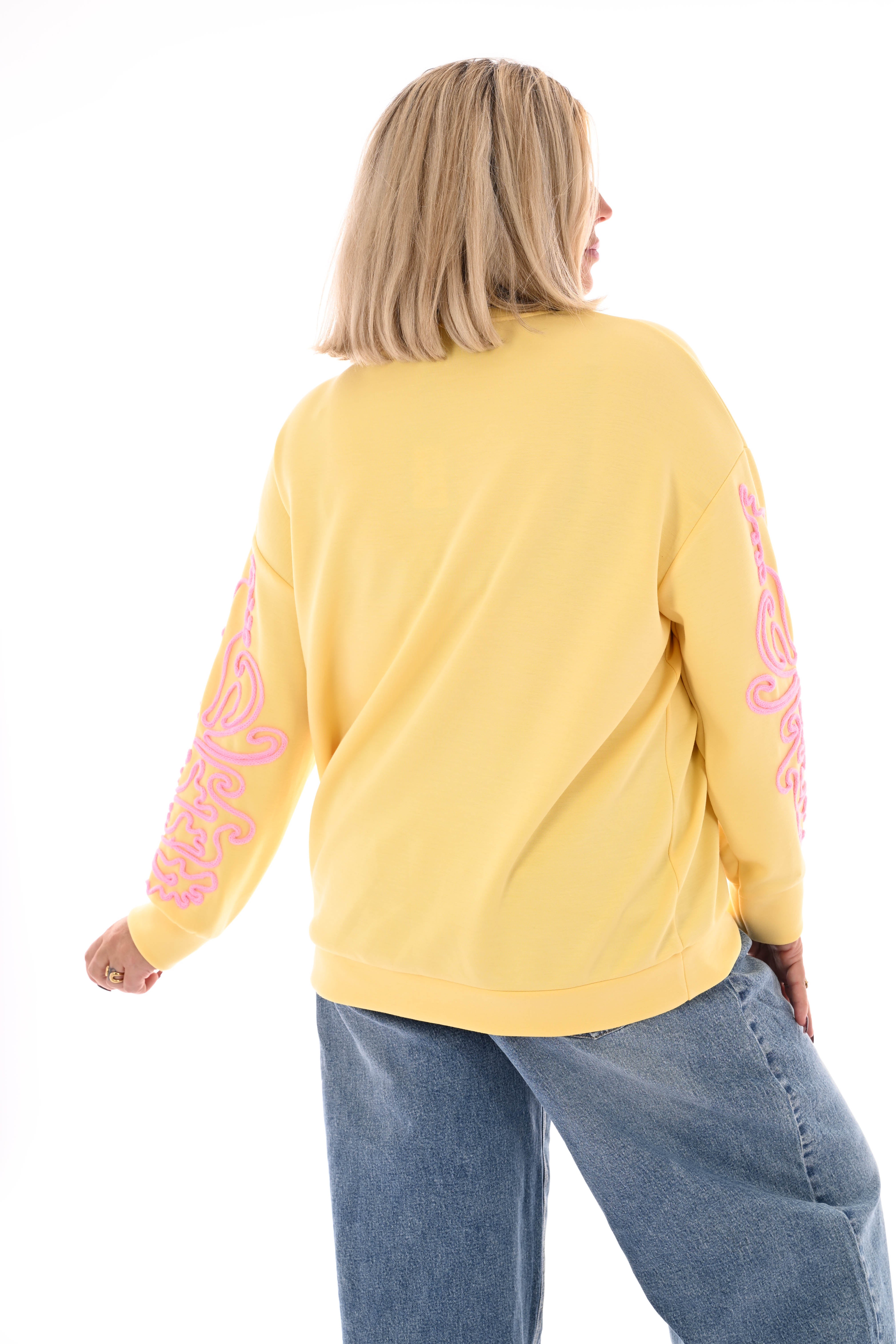 Sweater mouwen met borduursels geel