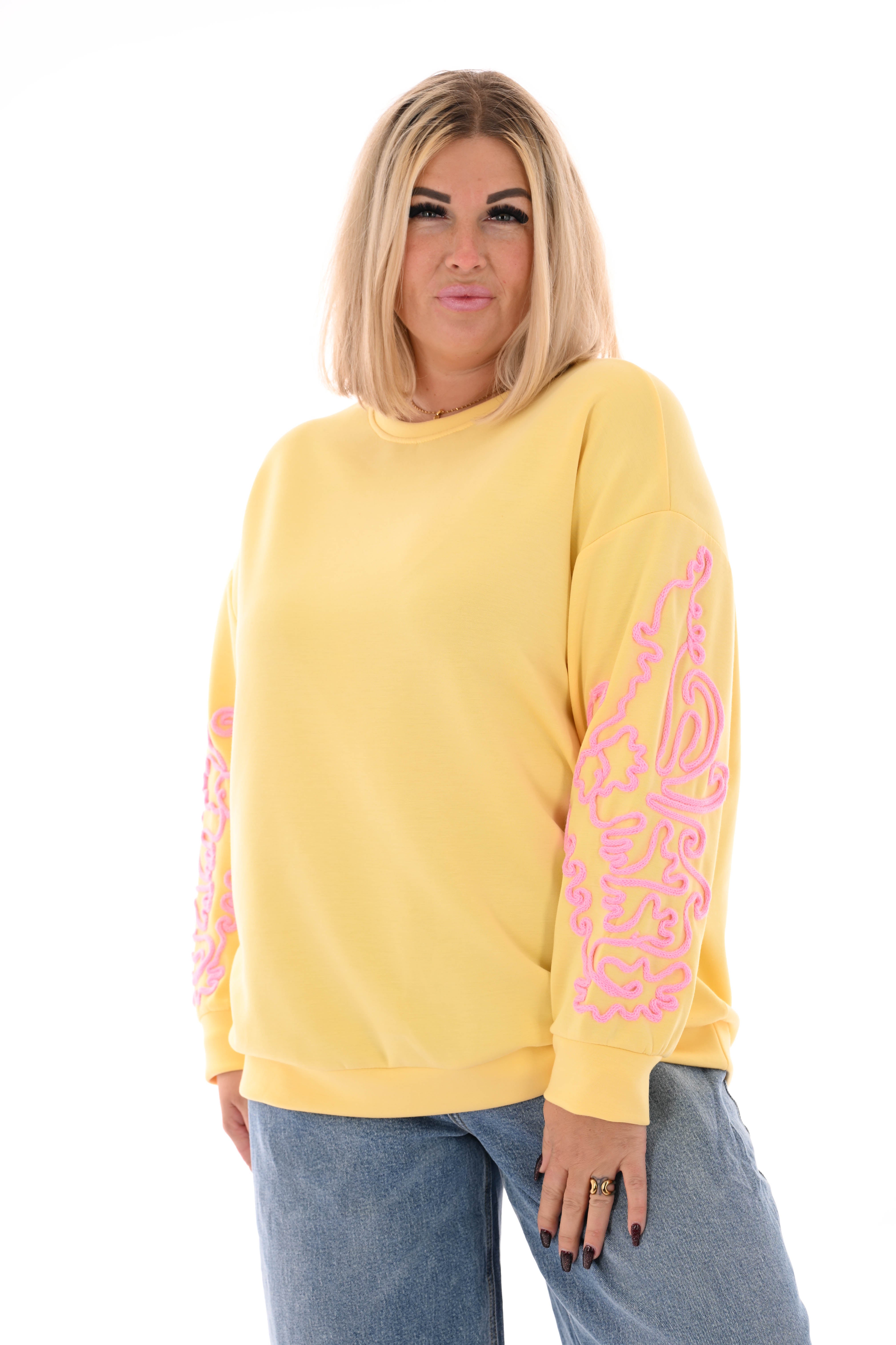 Sweater mouwen met borduursels geel